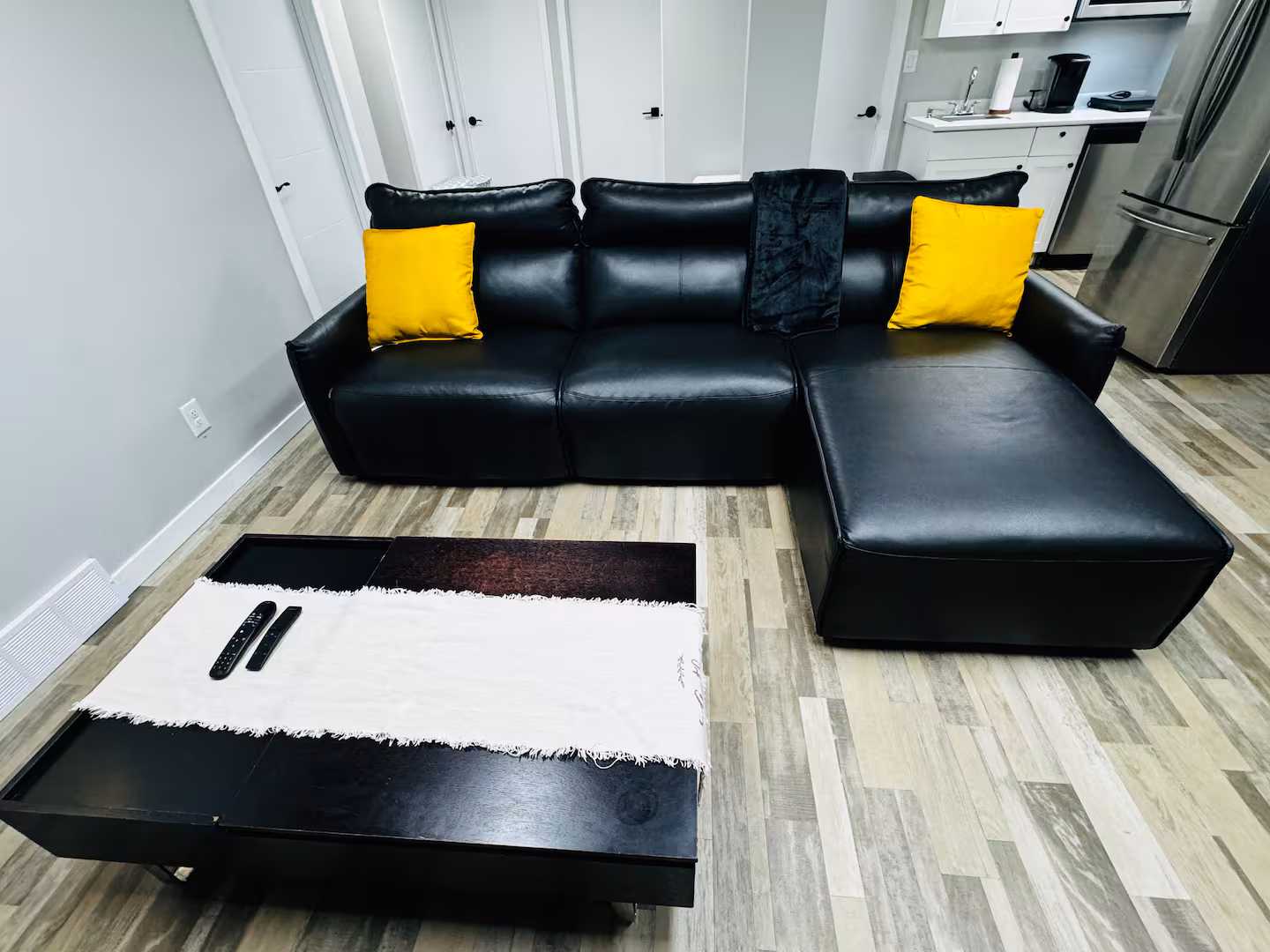 Modern Furnished Lounge with Black Leather Sectional